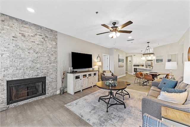 3404 American Dr Unit 3221, Lago Vista, TX 78645 - living area with wood finished floors, a ceiling fan, a fireplace, baseboards, and recessed lighting