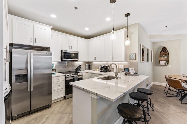 3404 American Dr Unit 3221, Lago Vista, TX 78645 - kitchen with appliances with stainless steel finishes, a sink, a peninsula, backsplash, and recessed lighting