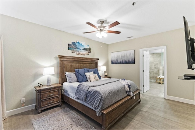 3404 American Dr Unit 3221, Lago Vista, TX 78645 - bedroom featuring light wood-type flooring, baseboards, ensuite bathroom, and ceiling fan