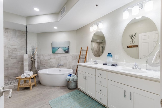 3404 American Dr Unit 3221, Lago Vista, TX 78645 - bathroom featuring tile walls, double vanity, a freestanding bath, and a shower