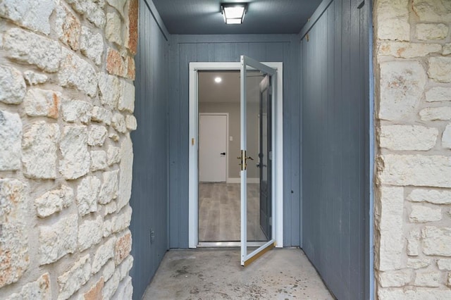 doorway to property with stone siding