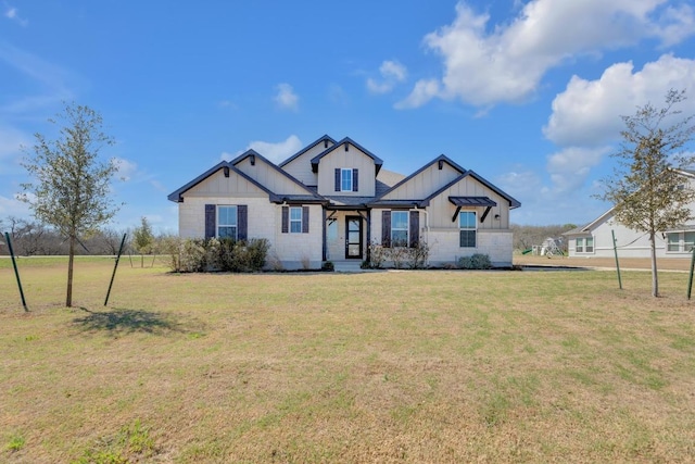 modern farmhouse style home with board and batten siding and a front yard