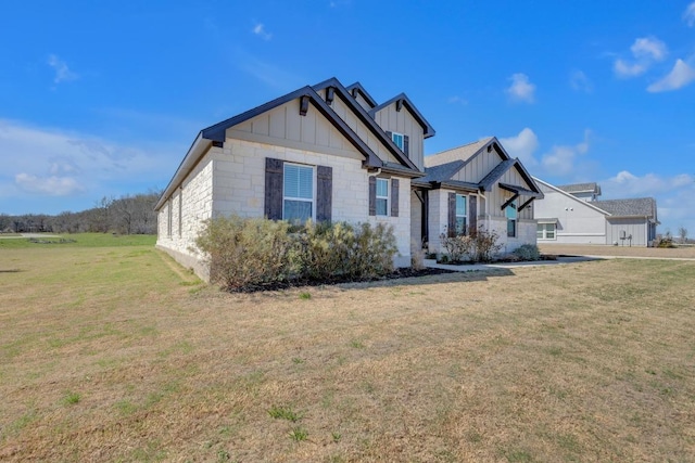 view of front of property featuring a front lawn and board and batten siding