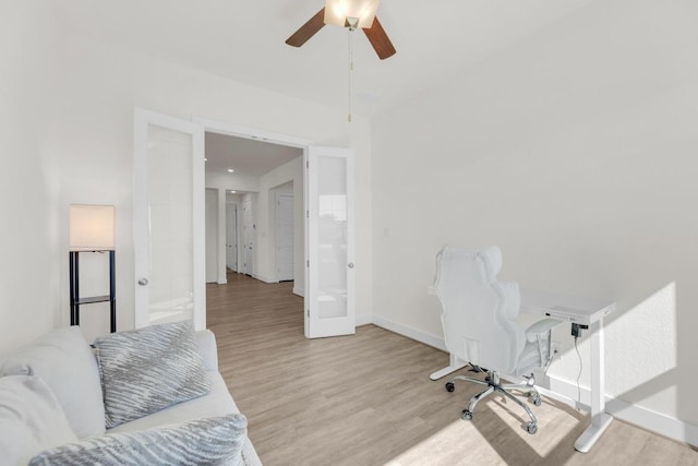 office area featuring a ceiling fan, baseboards, and wood finished floors