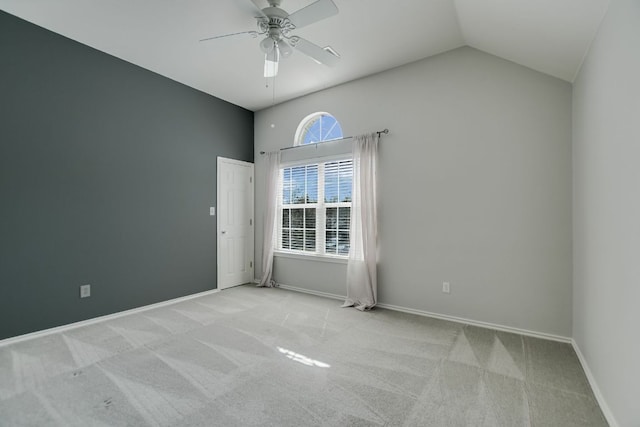 unfurnished room with lofted ceiling, ceiling fan, baseboards, and carpet flooring