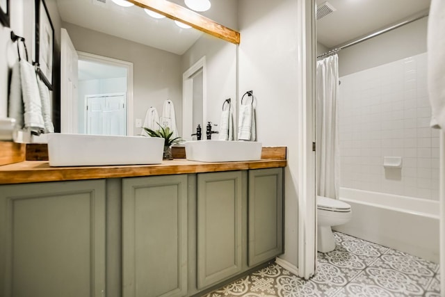 bathroom featuring toilet, a sink, visible vents, double vanity, and shower / bathtub combination with curtain