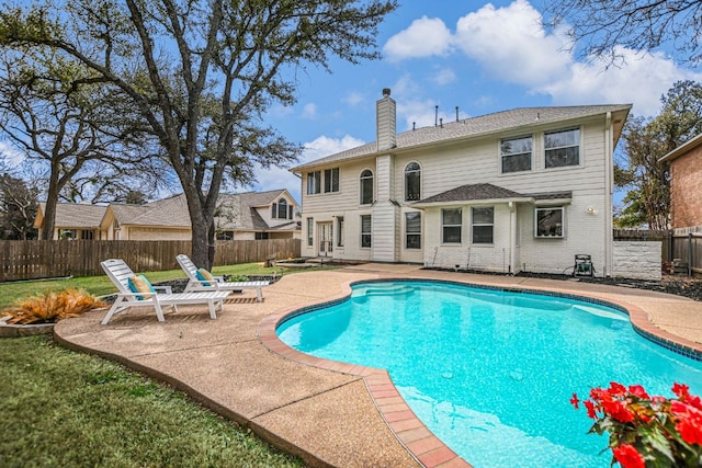 view of pool with a yard, a fenced backyard, a fenced in pool, and a patio