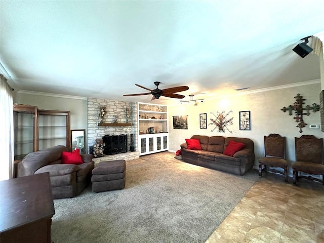 living area with ceiling fan, visible vents, crown molding, and a stone fireplace