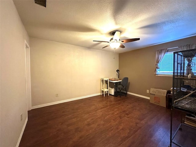 office area with baseboards, visible vents, ceiling fan, wood finished floors, and a textured ceiling