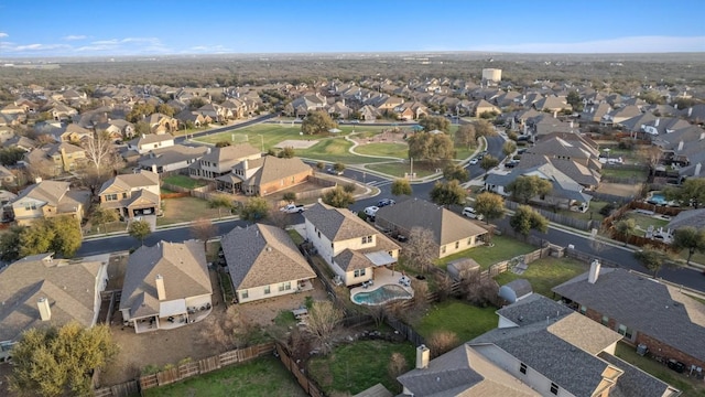 aerial view of property and surrounding area featuring nearby suburban area