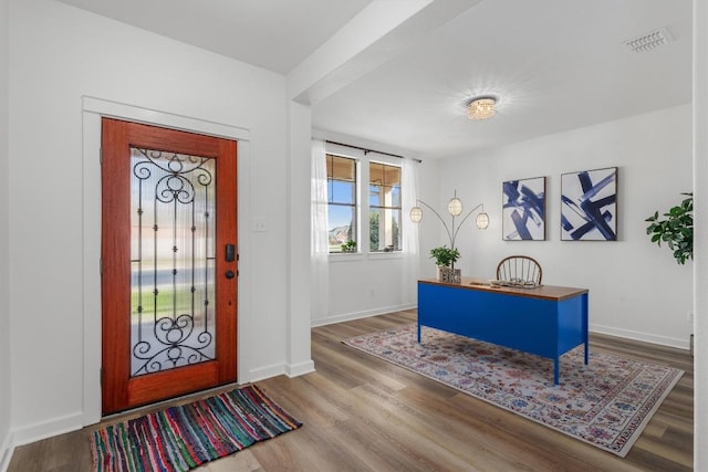 entrance foyer featuring visible vents, baseboards, and wood finished floors