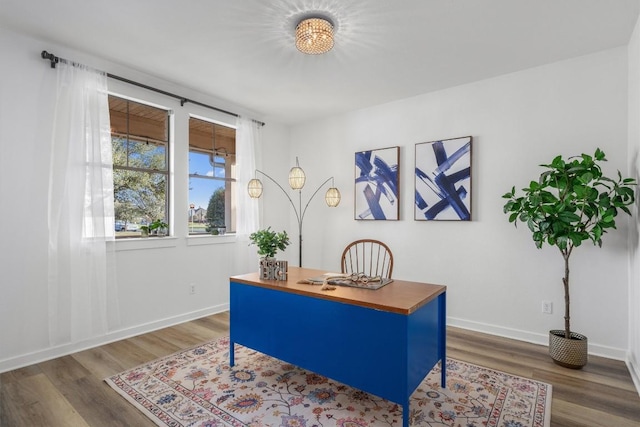 office space with wood finished floors and baseboards