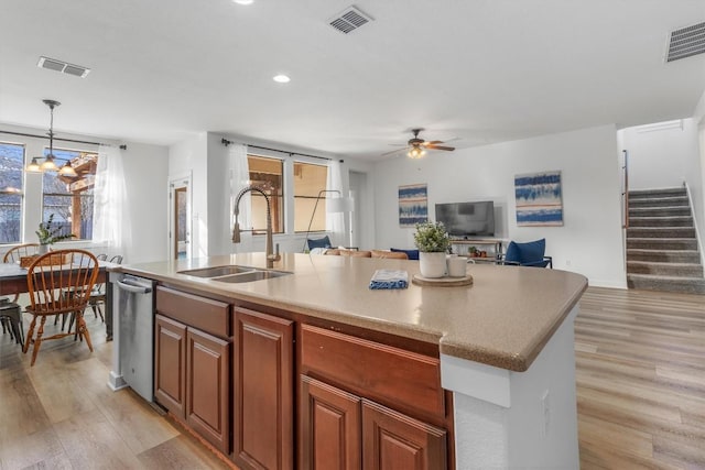 kitchen featuring plenty of natural light, visible vents, and a sink