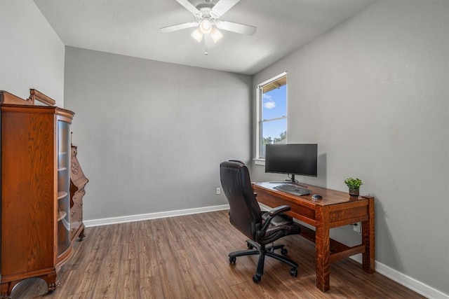 office with a ceiling fan, baseboards, and wood finished floors