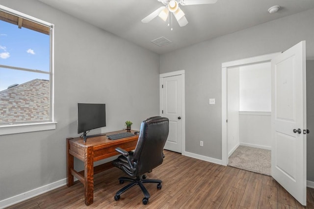 office space with ceiling fan, wood finished floors, visible vents, and baseboards