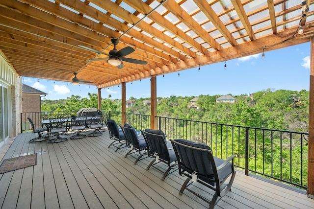 deck featuring outdoor dining area and a ceiling fan