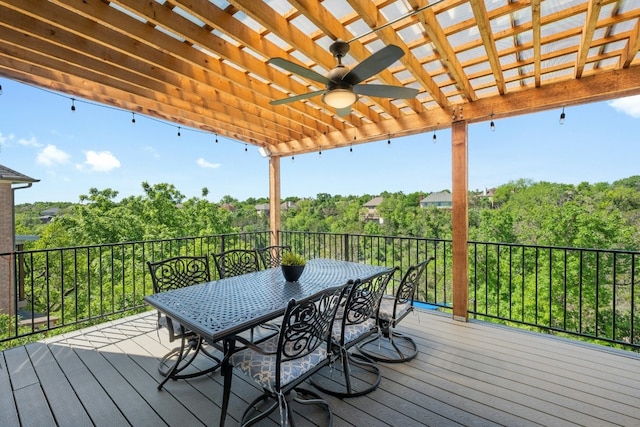 wooden terrace featuring outdoor dining space and a ceiling fan