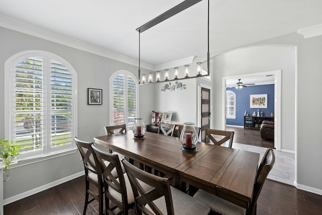 dining room featuring a wealth of natural light, arched walkways, wood-type flooring, and ceiling fan