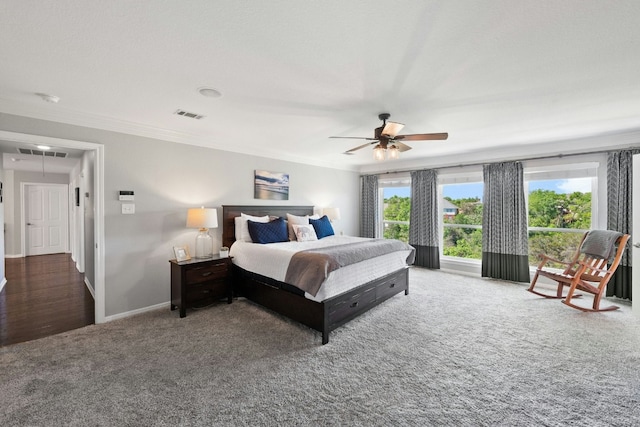 carpeted bedroom featuring attic access, visible vents, ceiling fan, and baseboards