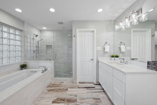 bathroom featuring visible vents, vanity, a shower stall, a bath, and recessed lighting