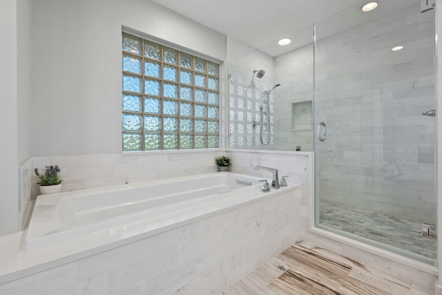 full bath with wood finished floors, a shower stall, and a bath