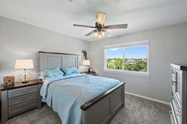 carpeted bedroom with ceiling fan and baseboards