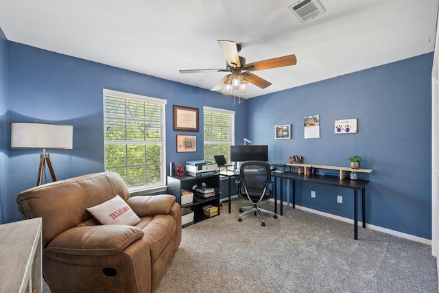 home office featuring a ceiling fan, carpet flooring, visible vents, and baseboards