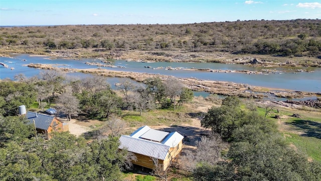 bird's eye view with a water view and a forest view