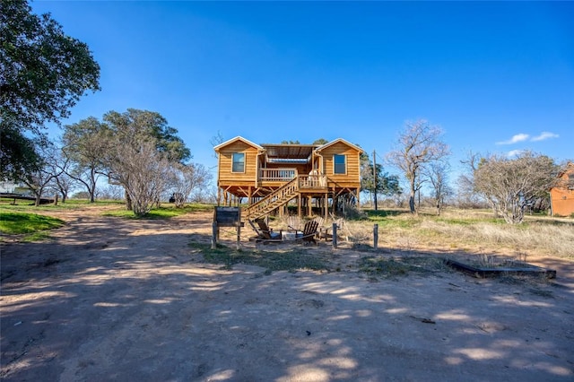 view of front of home with a deck and stairs