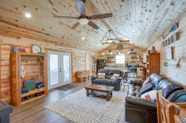 living area with wooden walls, wooden ceiling, light wood-style flooring, vaulted ceiling, and french doors