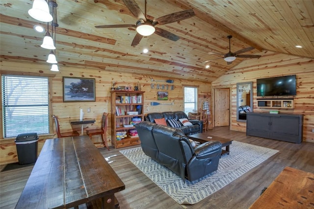 living area featuring wooden ceiling, wooden walls, vaulted ceiling, and a wealth of natural light