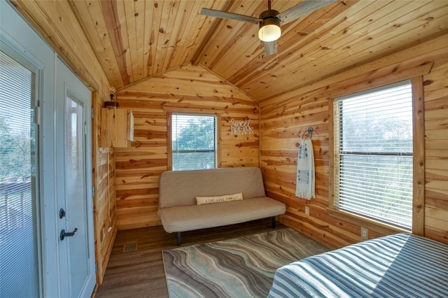 bedroom featuring wood ceiling, wooden walls, vaulted ceiling, and wood finished floors