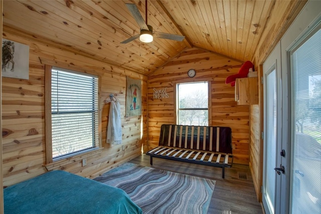 bedroom featuring wood ceiling, wooden walls, vaulted ceiling, and wood finished floors