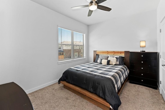 carpeted bedroom featuring ceiling fan and baseboards