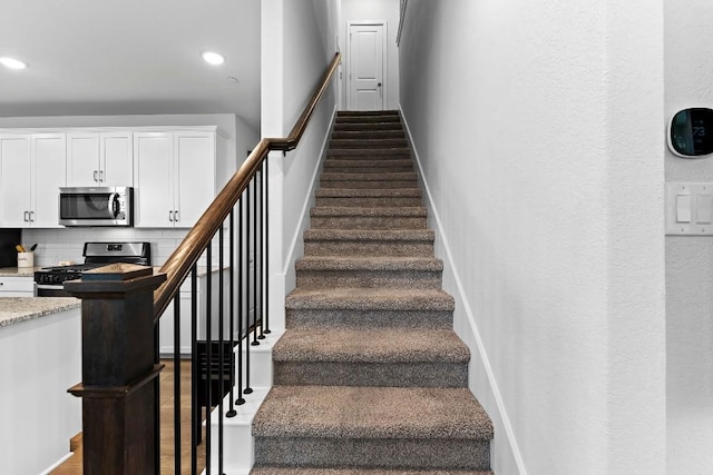 staircase featuring recessed lighting and baseboards