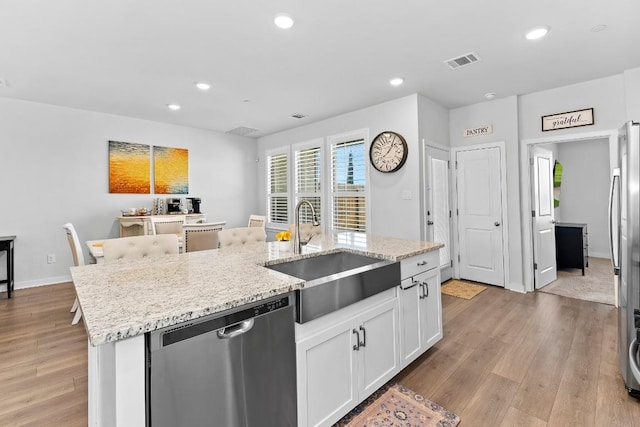 kitchen with light wood-type flooring, visible vents, a sink, recessed lighting, and stainless steel appliances