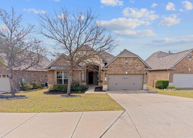 view of front facade with an attached garage, cooling unit, brick siding, concrete driveway, and a front yard