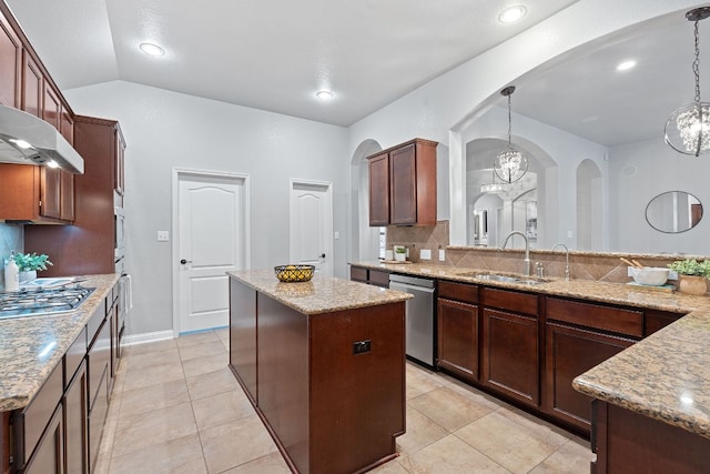 4801 Pyrenees Pass, Bee Cave, TX 78738 - kitchen with a sink, appliances with stainless steel finishes, arched walkways, a chandelier, and a center island