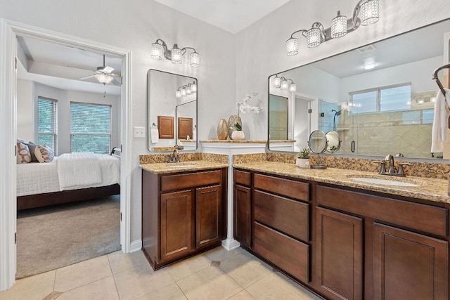 4801 Pyrenees Pass, Bee Cave, TX 78738 - ensuite bathroom featuring a shower stall, ceiling fan, vanity, tile patterned floors, and baseboards