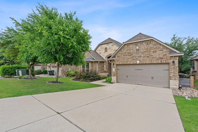 4801 Pyrenees Pass, Bee Cave, TX 78738 - view of front facade featuring a garage, concrete driveway, a front lawn, brick siding, and stone siding