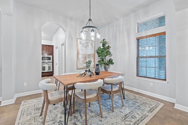 4801 Pyrenees Pass, Bee Cave, TX 78738 - dining room featuring arched walkways, a chandelier, and baseboards