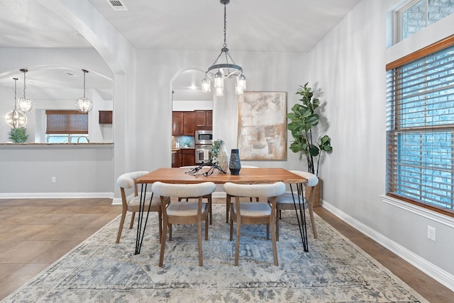 4801 Pyrenees Pass, Bee Cave, TX 78738 - dining space with a chandelier, arched walkways, and baseboards