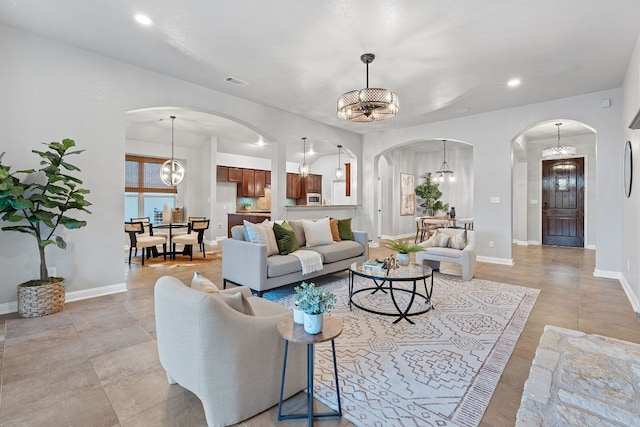 4801 Pyrenees Pass, Bee Cave, TX 78738 - living area featuring arched walkways, a chandelier, recessed lighting, baseboards, and plenty of natural light