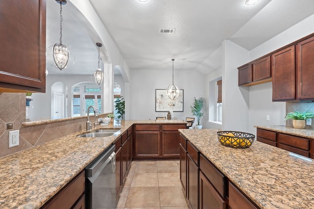 4801 Pyrenees Pass, Bee Cave, TX 78738 - kitchen with stainless steel dishwasher, arched walkways, backsplash, light stone countertops, and a chandelier