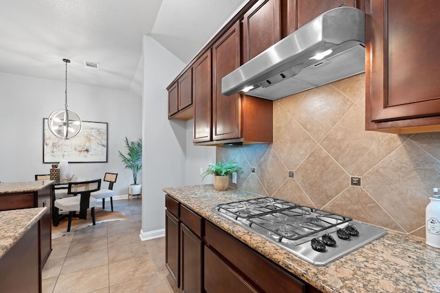 4801 Pyrenees Pass, Bee Cave, TX 78738 - kitchen featuring range hood, stainless steel gas cooktop, backsplash, hanging light fixtures, and a chandelier