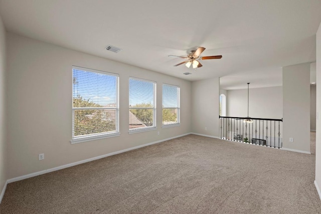 unfurnished room featuring a ceiling fan, baseboards, visible vents, and carpet flooring