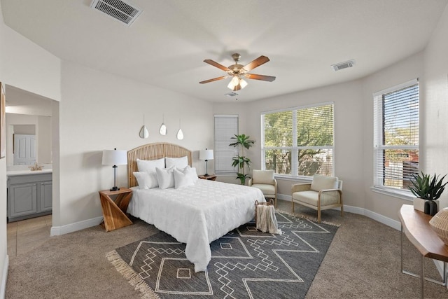 carpeted bedroom featuring baseboards, visible vents, and a ceiling fan