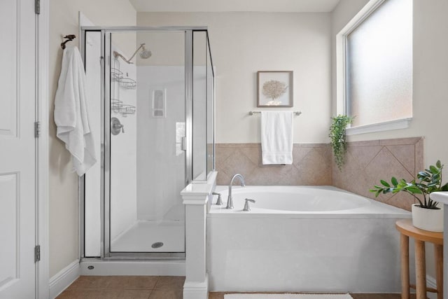 full bath with a stall shower, tile patterned flooring, and a garden tub