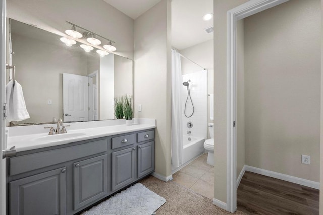 bathroom with toilet, shower / tub combo, vanity, tile patterned flooring, and baseboards