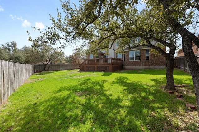 view of yard with a fenced backyard and a wooden deck